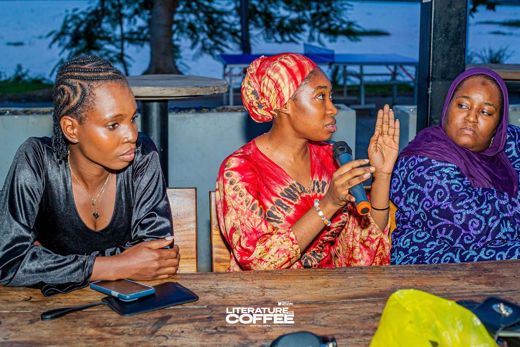 Three guests in conversation at a table.