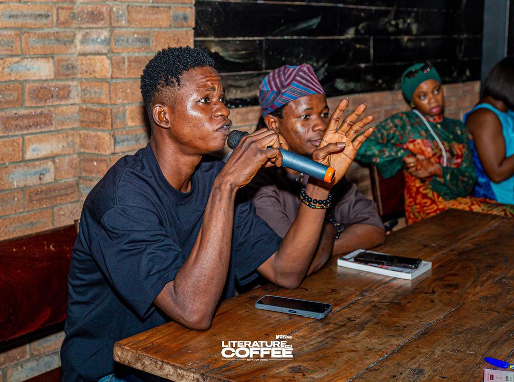 A young man speaks into a microphone during the debate.