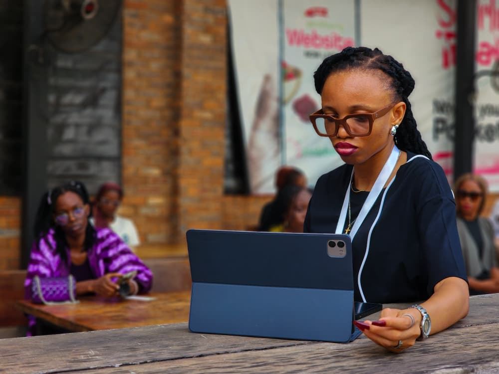 Stephanie Osaro working on a tablet at a Literature & Coffee NG gathering.