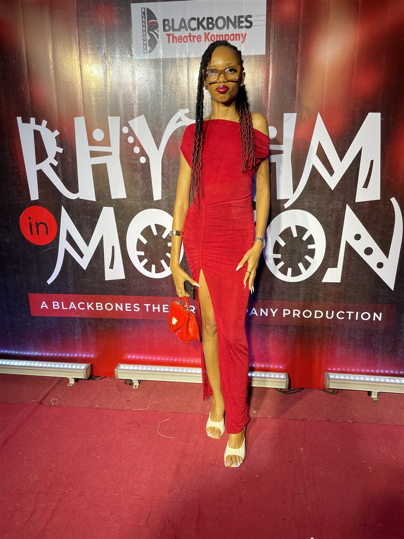 Stephanie Osaro in a red gown on the red carpet at a Blackbones Theatre Kompany production.